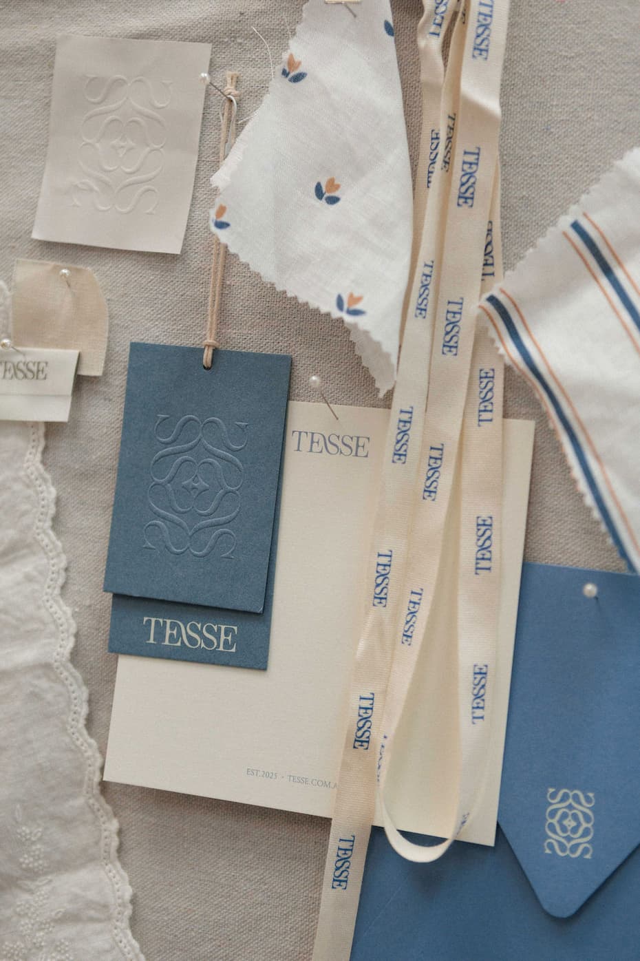 TESSE concept board with Matilda and Finley fabric swatches, swing tags and ribbon